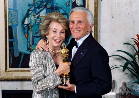 Anne Douglas and Kirk Douglas pose with an award.